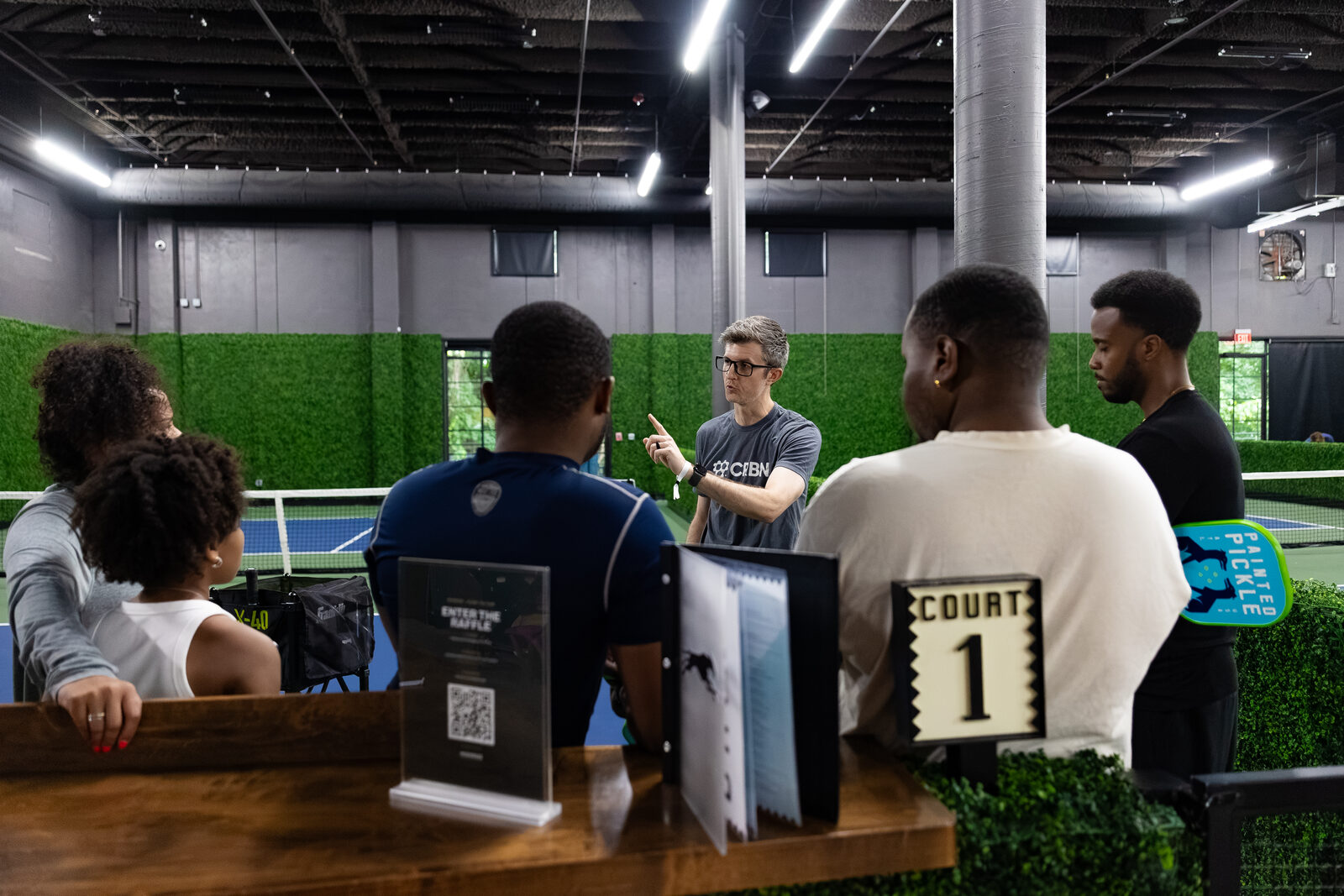 The beginner zone coach walking a small group through the rules before play