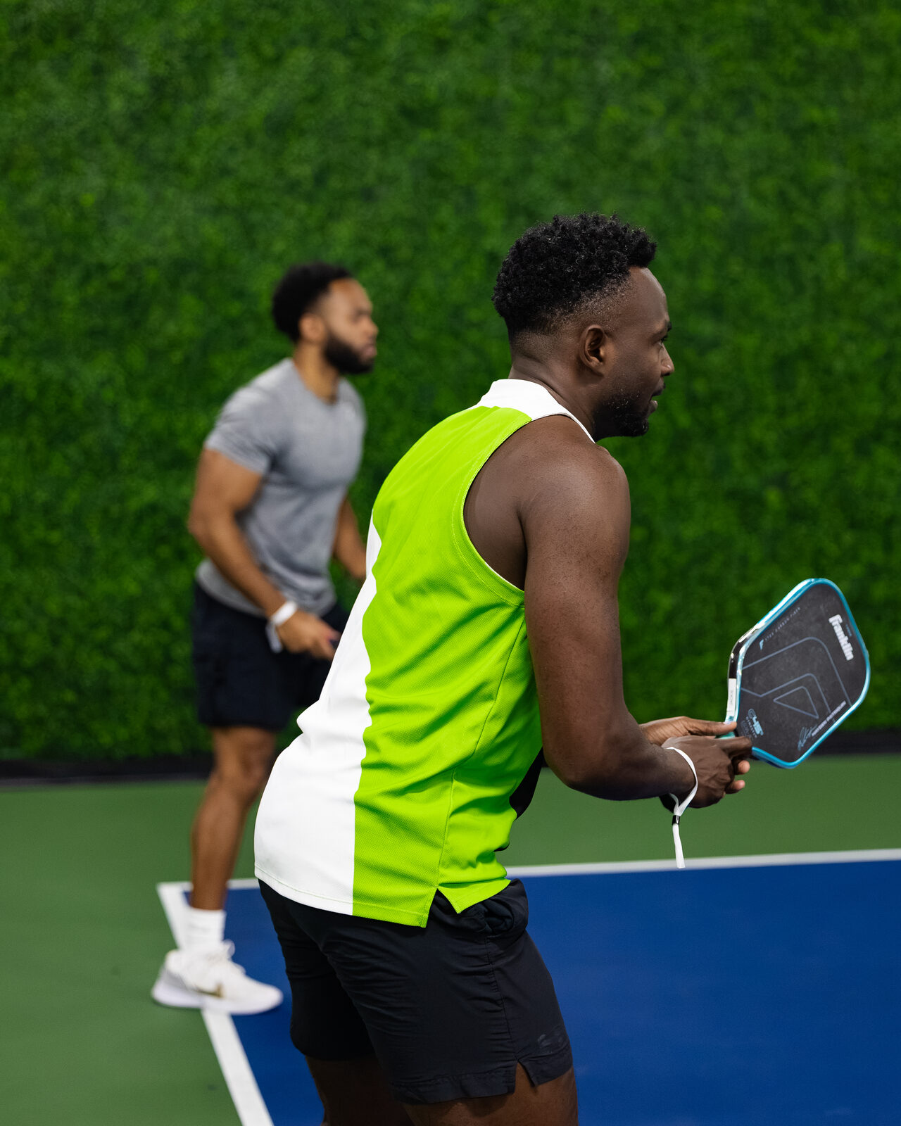 Two players in a doubles rally