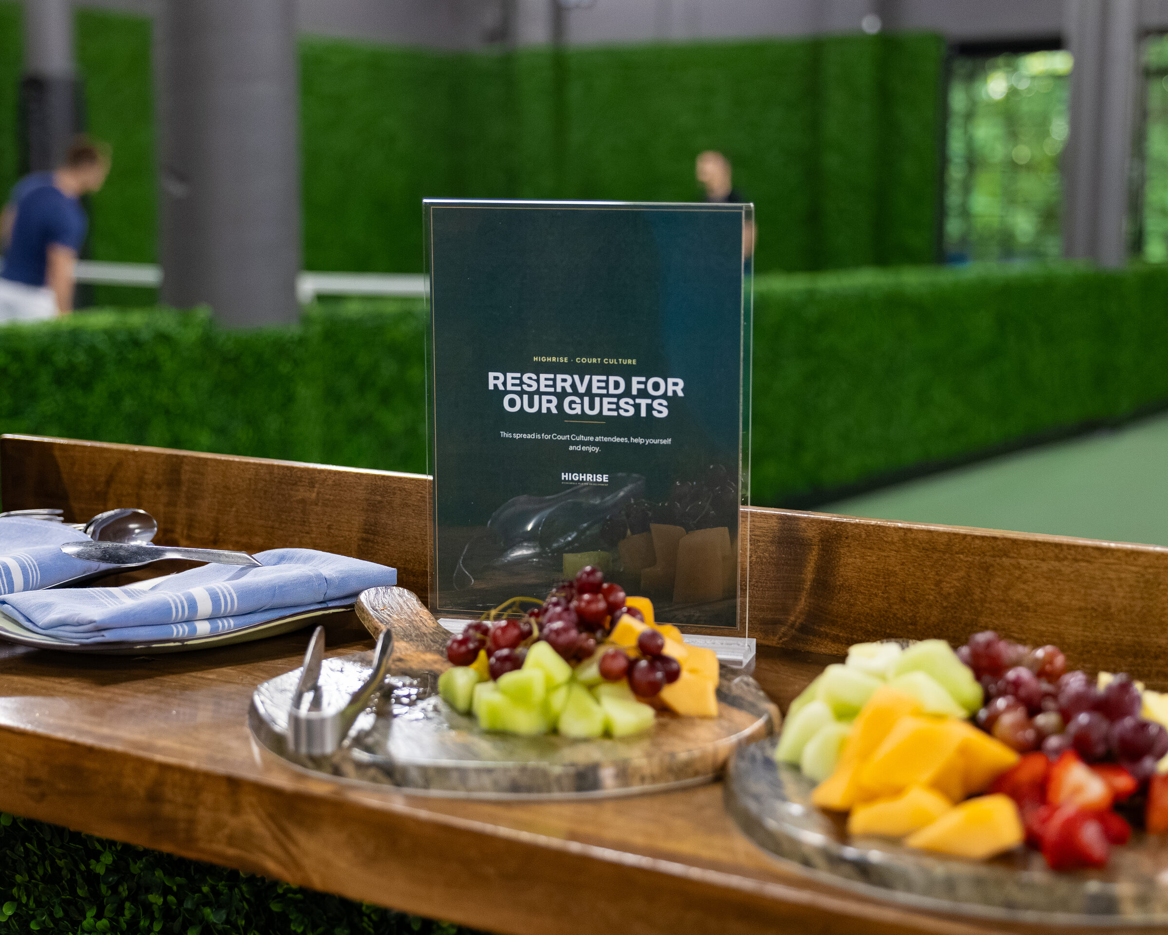 A reserved table set with a fresh fruit spread for guests