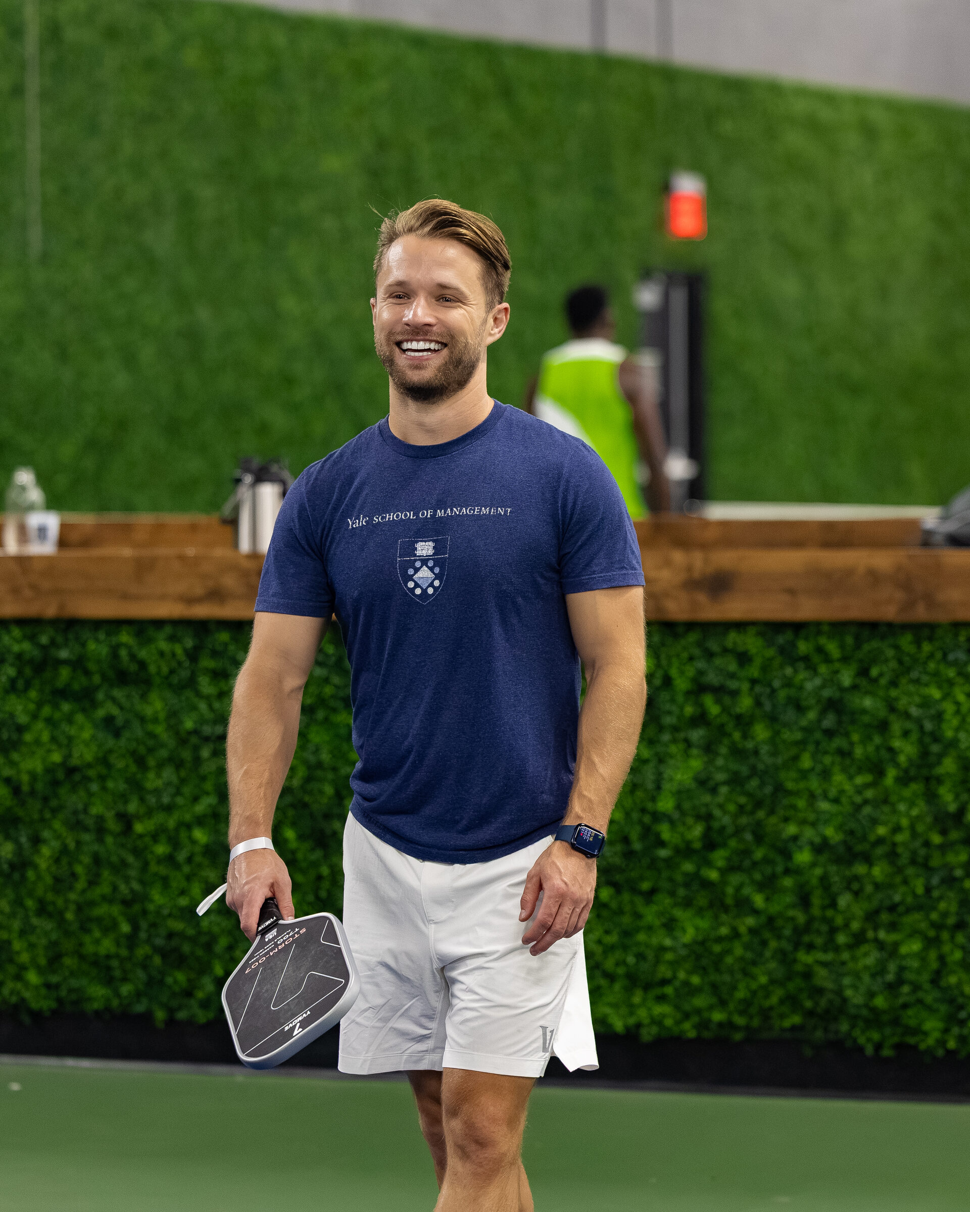 An attendee smiling courtside