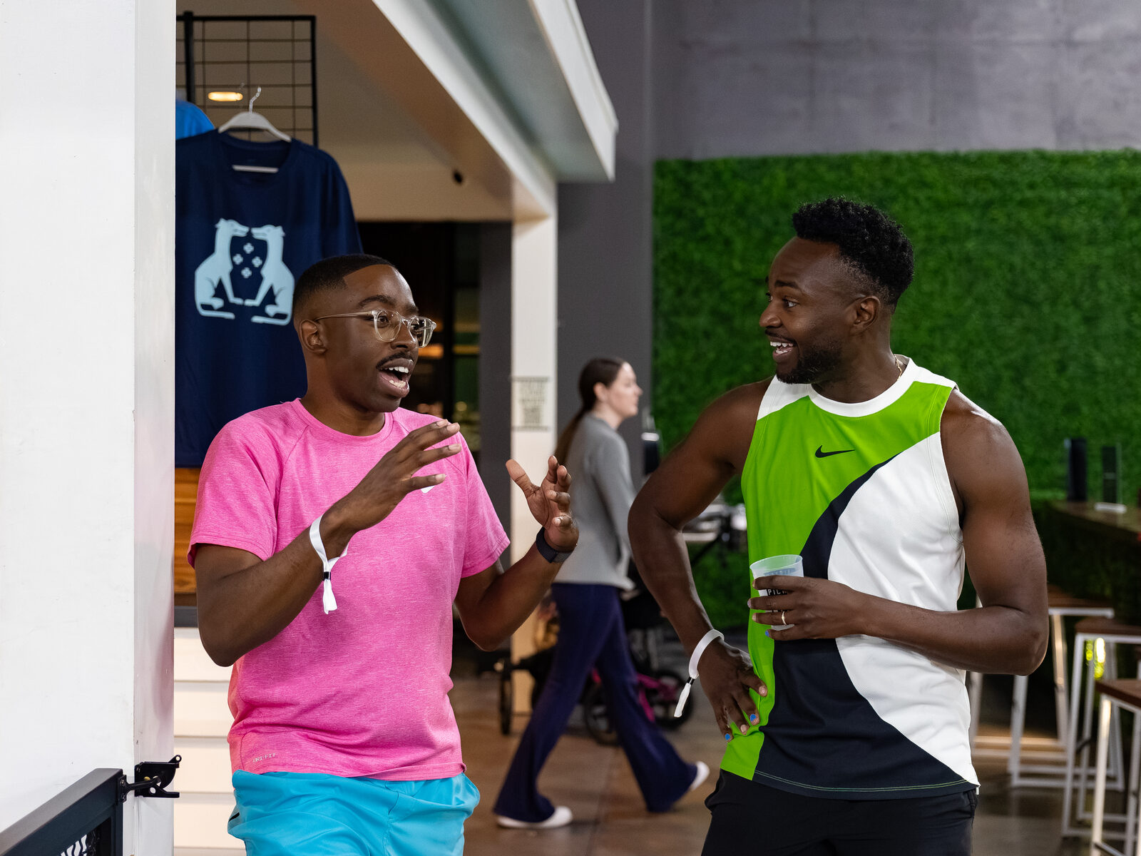 Two attendees laughing and talking off-court